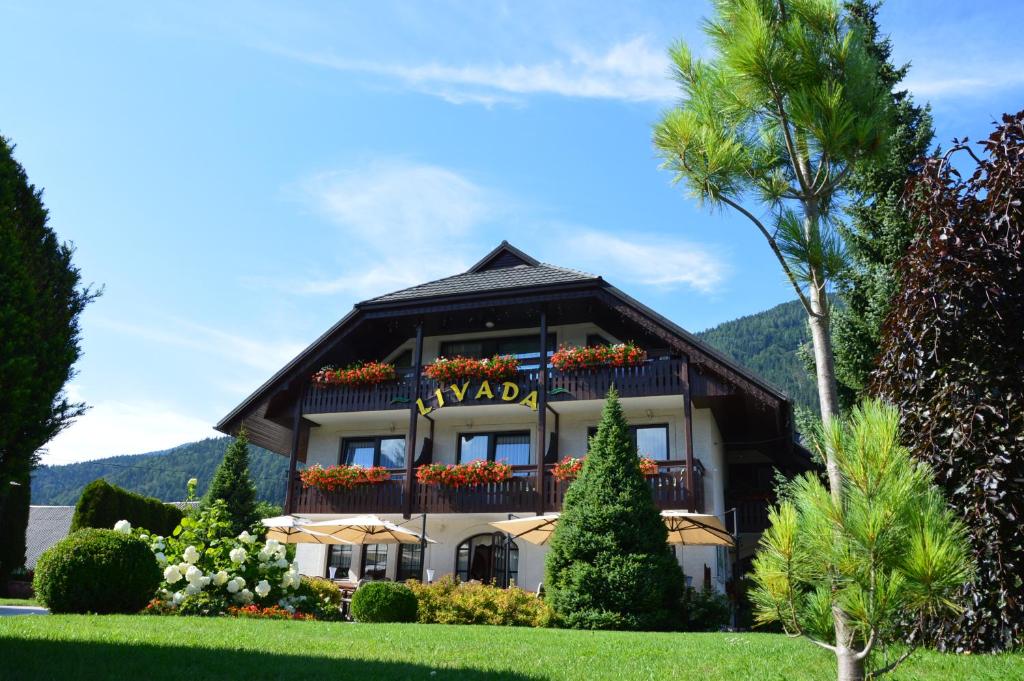 a house with a sign that reads navaho at Penzion Livada in Kranjska Gora