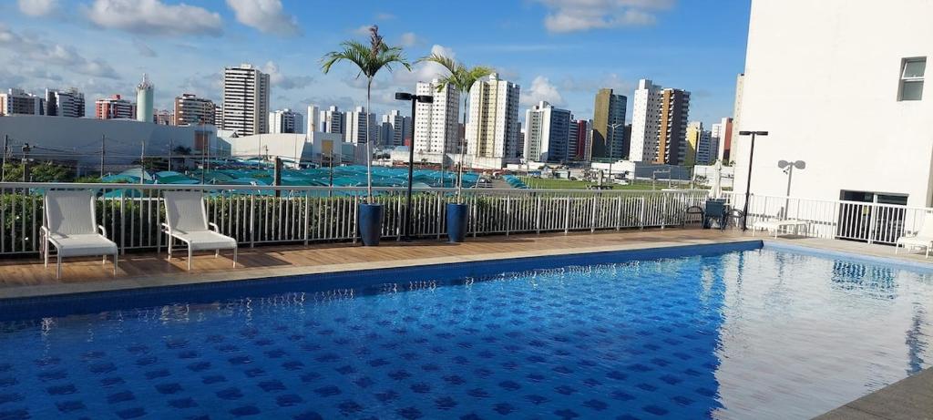 a swimming pool with a view of a city at Comfort Jardins II - Em frente ao Shopping- Neo Residence in Aracaju