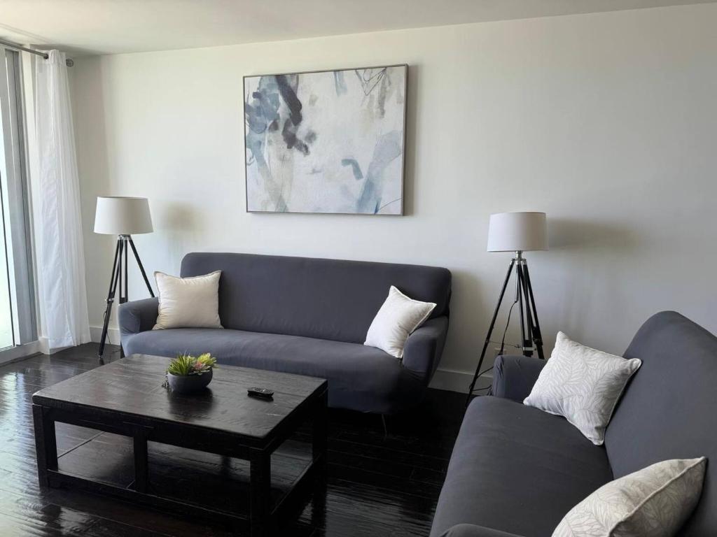 a living room with a couch and a coffee table at Beachfront 2BR at The Tides | EPIC Stay in Hollywood