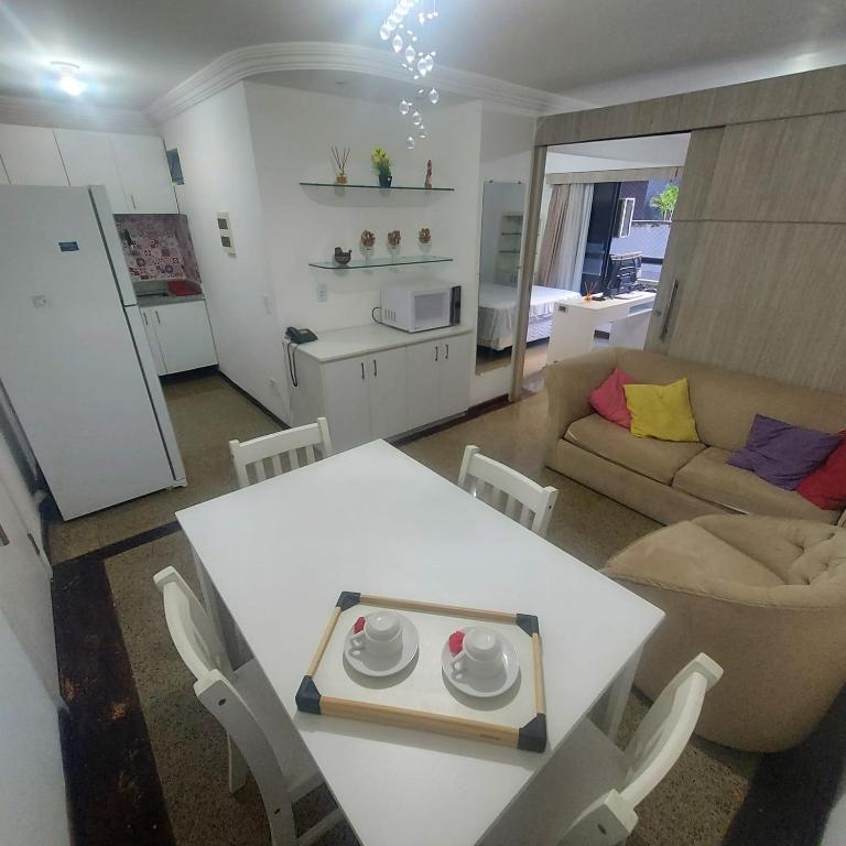 a kitchen and living room with a white table and chairs at Residence Scala in Fortaleza