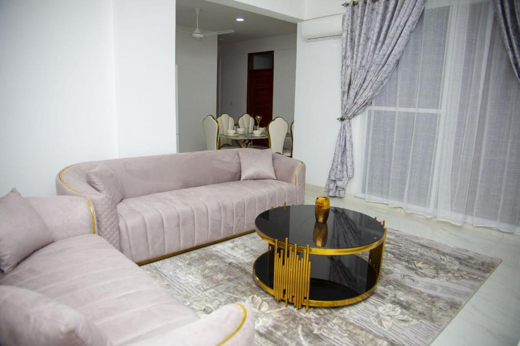 a living room with a couch and a coffee table at Havah Zanzibar Home in Mwanakwerekwe