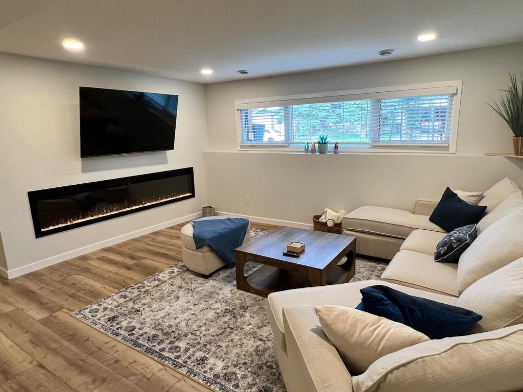 a living room with a couch and a fireplace at The West Wind Retreat in Lethbridge