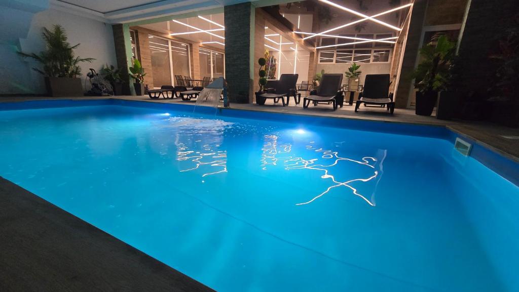 a swimming pool with blue lighting in a hotel at Bazen za uzivanje in Petrovaradin