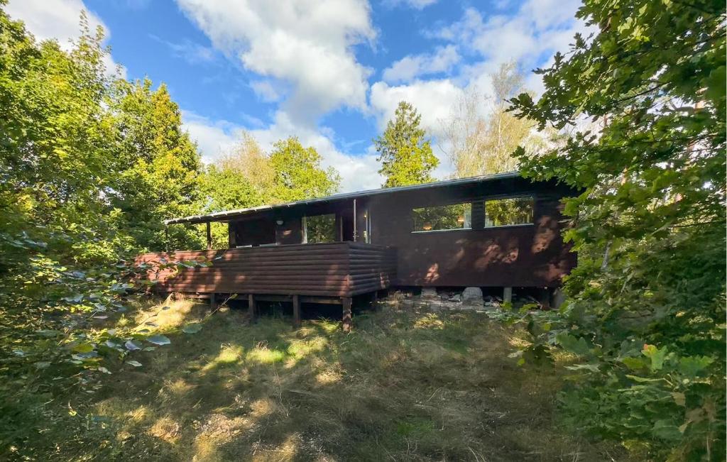 an old train car is sitting in the woods at Amazing Home In Aakirkeby With Wifi in Boderne