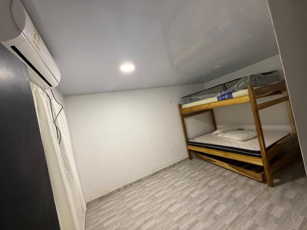 a small room with a bunk bed in it at SC Essence paradise in Necoclí