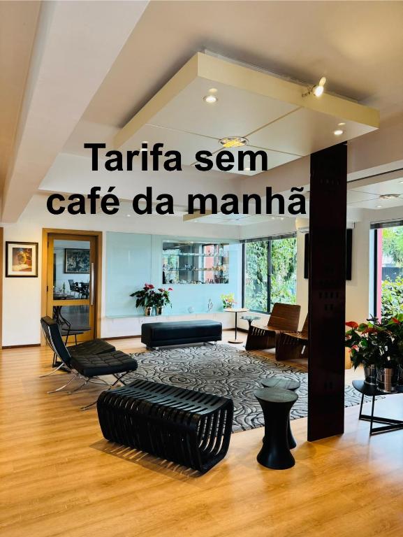 a living room with a sign that reads caffe sen cafe de manana at Hotel Germânia in Joinville