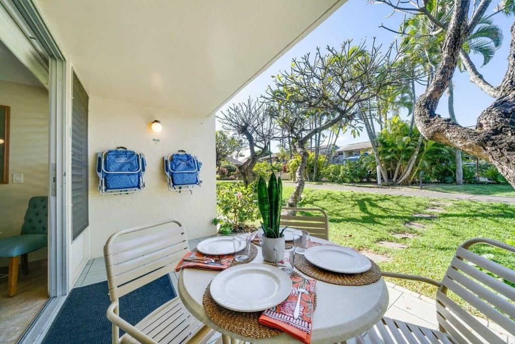 a table and chairs on the porch of a house at Napili Shores D126 · NSD126 Cozy Studio Steps to Beach in Kahana