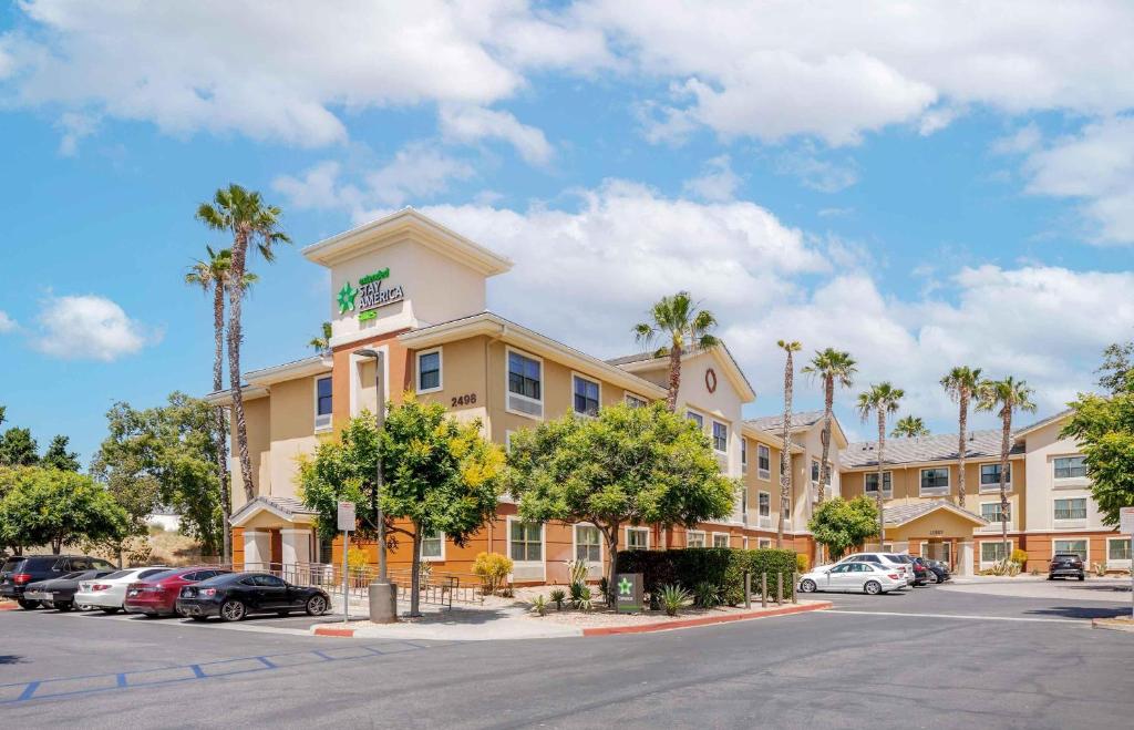 a hotel with palm trees in a parking lot at Extended Stay America Suites - Los Angeles - Simi Valley in Santa Susana Knolls