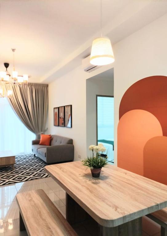 a living room with a table and a couch at Semarak Homestay@Alisya Package in Kajang