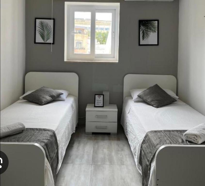 a bedroom with two beds and a window at Seaview Greenland 