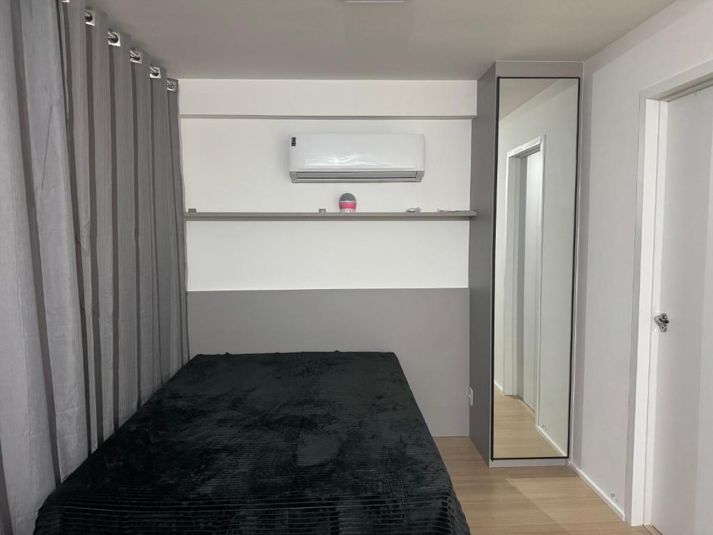 a room with a bed and a mirror in it at SouMaisTemporada RJ in Niterói