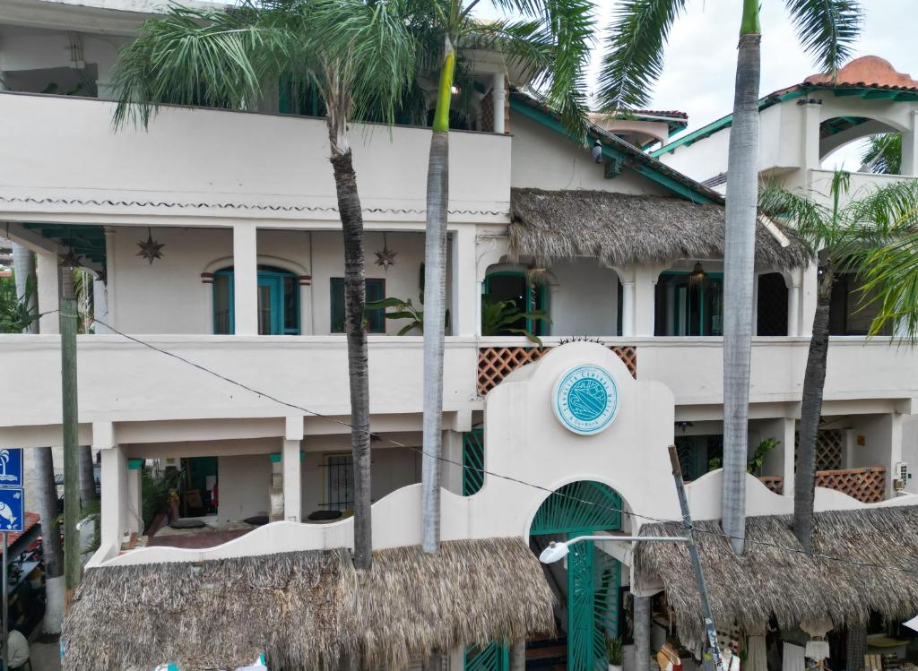 a building with a blue clock on the side of it at Sayulita Central Hotel in Sayulita