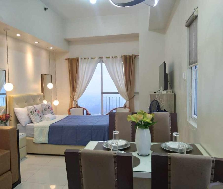 Voodi või voodid majutusasutuse Tagaytay Smdc Wind Residences by Le Grand Liz's Place toas