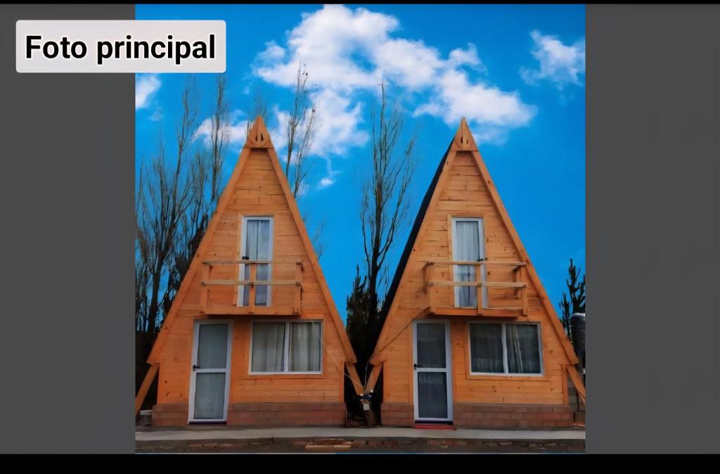 a house with two pointed roofs at Cabaña anita in Perito Moreno