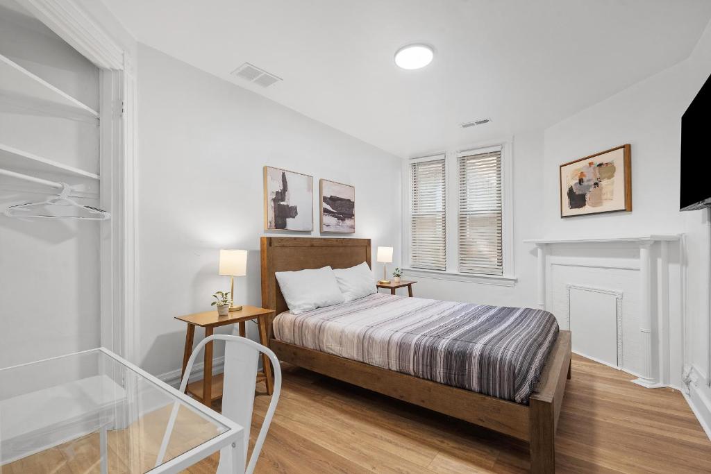 a bedroom with a bed and two tables and a window at Pittsburgh Shadyside 1C Spacious and Cozy Private Bedroom with Shared Bathroom in Pittsburgh