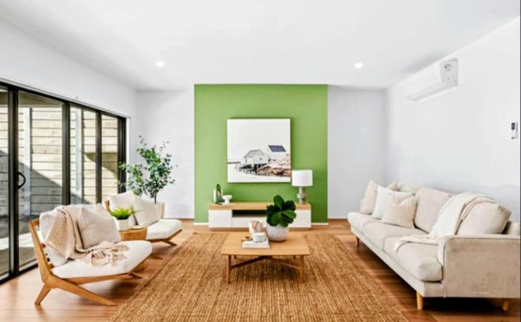 a living room with a couch and a table at Stylish Modern Getaway Geelong in Geelong