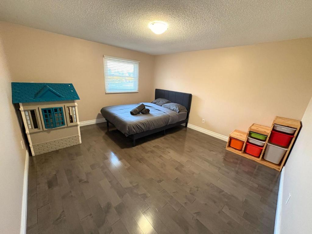 ミシサガにあるPerfect Friends & Family Getaway - Spacious 3BR with Backyardのウッドフロアのベッドルーム1室(ベッド1台付)