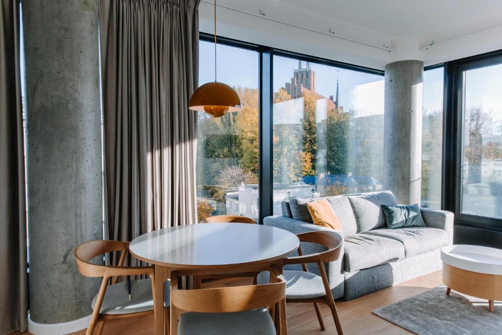 a living room with a table and a couch at Aparthotel Park - By The Sea in Gdynia