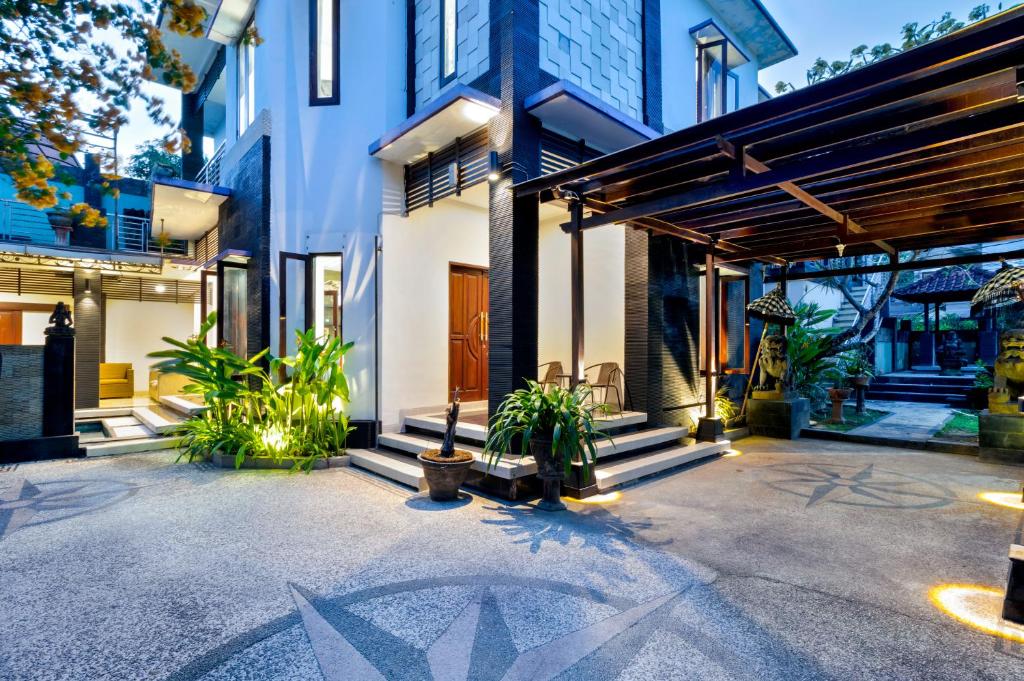 a house with a courtyard with plants at 5-Bedroom Private Villa near Padma Beach, Legian in Legian