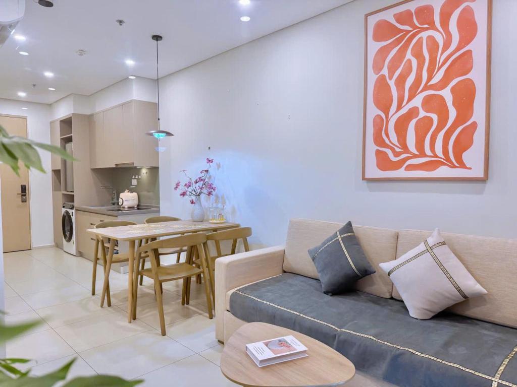 a living room with a couch and a table at The Song Apartment Vung Tau 5 star-Căn Hộ The Sóng -Moon Homestay in Vung Tau