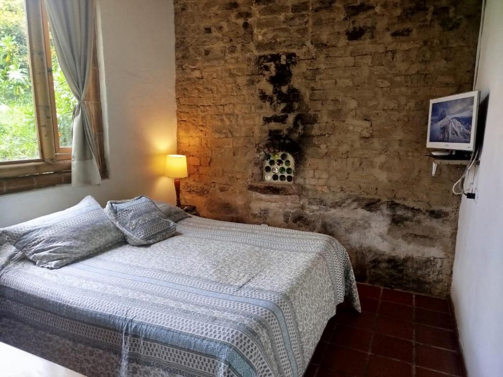 Ένα ή περισσότερα κρεβάτια σε δωμάτιο στο HOSTAL CASA DE GUADUA/ THE BAMBOO HOUSE
