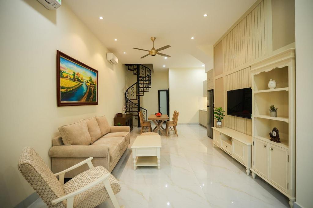 ein Wohnzimmer mit Sofa und Fernseher in der Unterkunft M&M homestay in Quang Tri