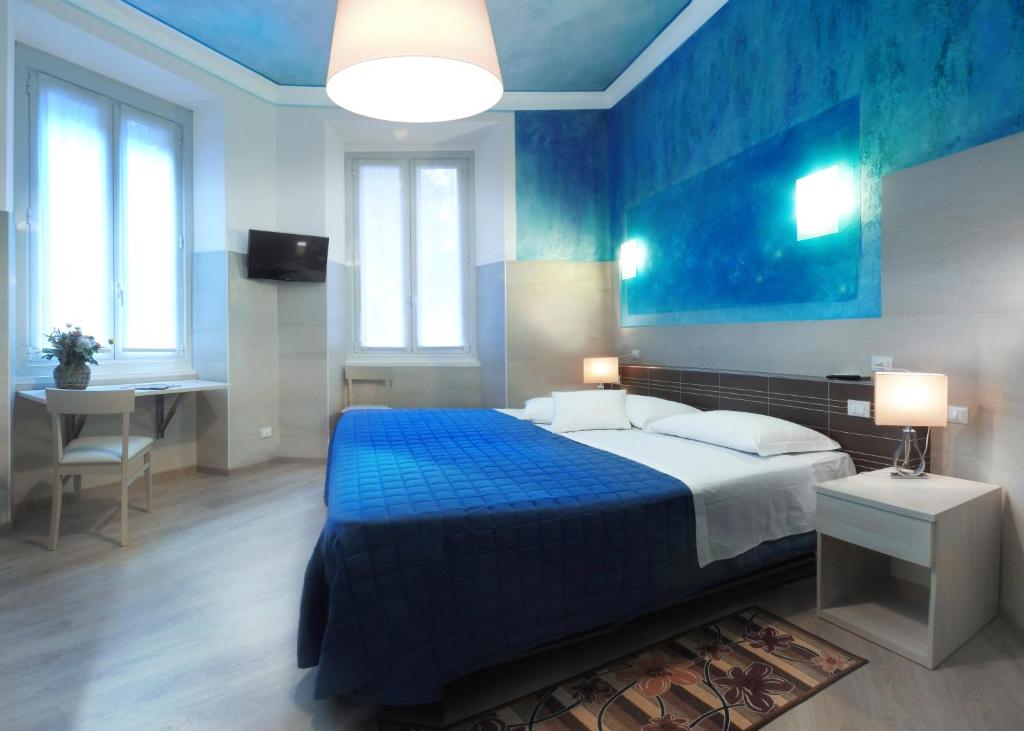 a blue bedroom with a bed and a desk at Albergo Annabella in Santa Margherita Ligure