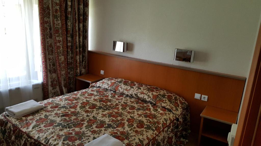 Postel nebo postele na pokoji v ubytování Hotel Bellevue