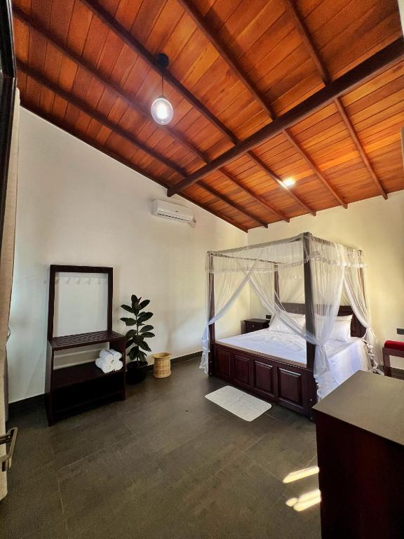 a bedroom with a bed and a wooden ceiling at Stay199 in Haragama