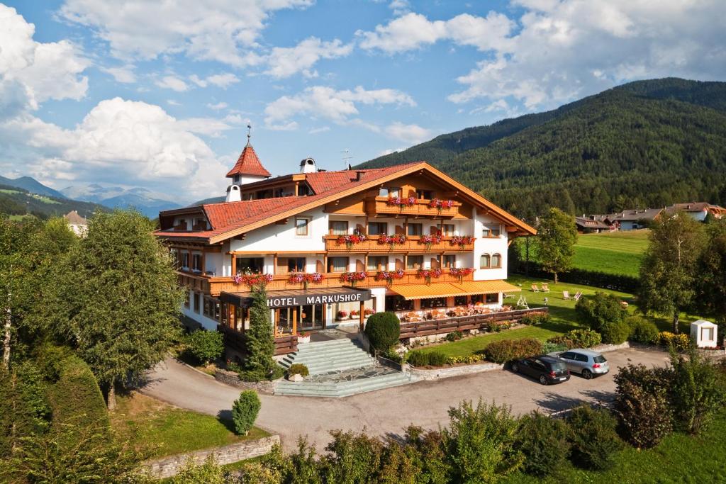 a large house with a large view of the mountains at Hotel Markushof 3***S in Valdaora