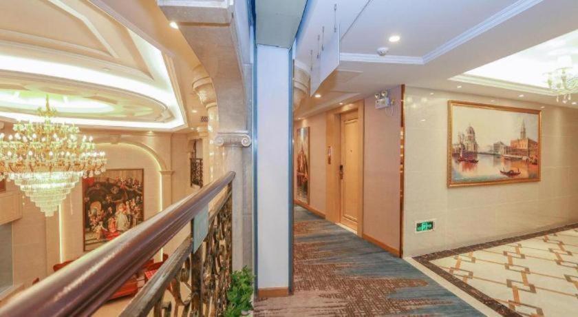a hallway in a building with a chandelier at SHANGJINGHAO HOTEL （SAKATA SNOW ELEPHANT SUBWAY STATION SHOP） in Lung Wa