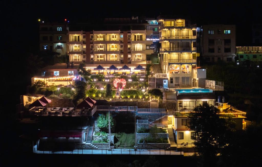 - une vue sur un hôtel la nuit avec des lumières dans l'établissement Village Highland Resort, à Godāvari