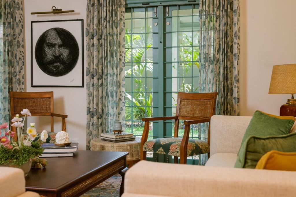 a living room with a couch and a table at Mammootty House Kochi - a VKation Experience in Cochin