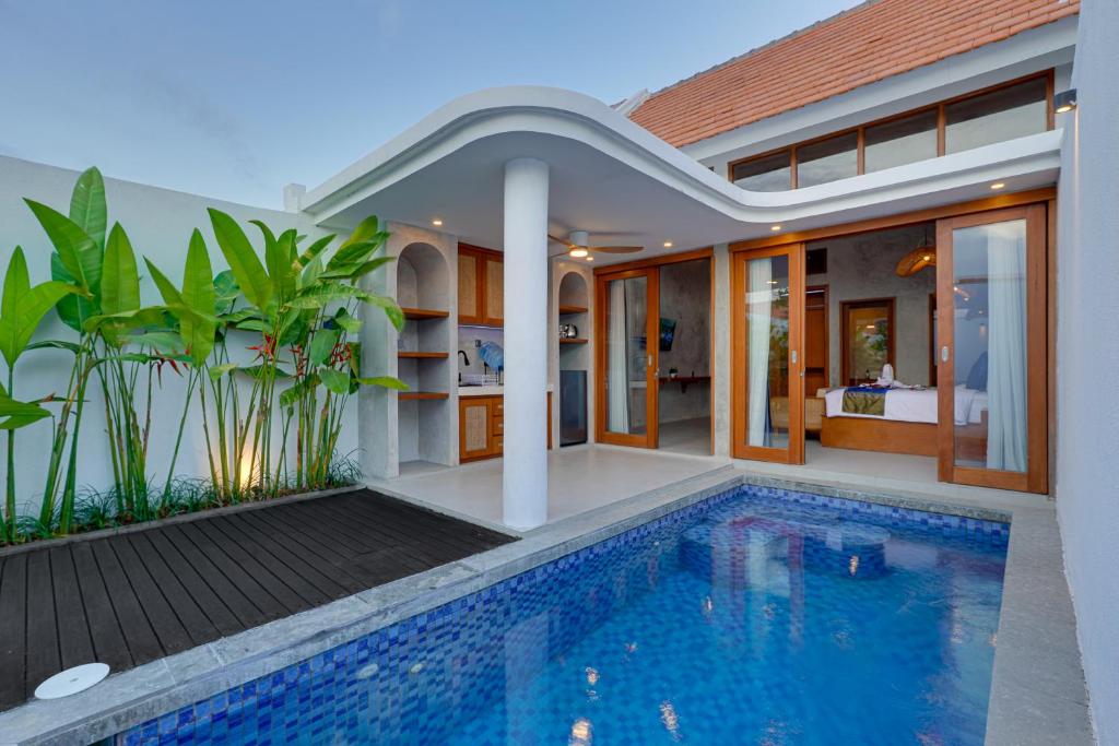 a house with a swimming pool in front of it at Elegant 1BR Villa Jasmine LaLuxe A11 Sanur in Sanur