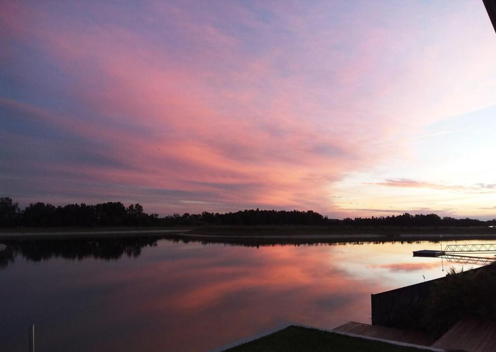 a view of a lake with a sunset in the background at Studio 21 Waterfront in Yamba