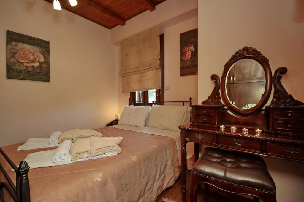 Postel nebo postele na pokoji v ubytování Menalia Villas & Suites ΚΤΗΜΑ ΚΟΥΜΠΟΥΡΗ