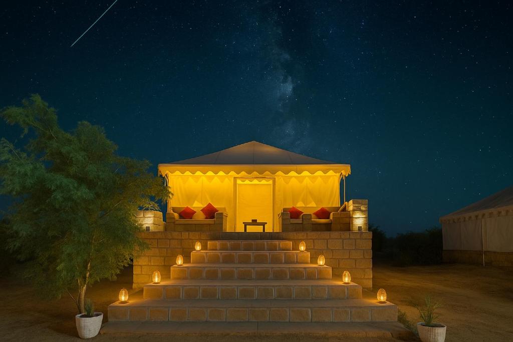 a gazebo with lights on the stairs at night at Desert Island Camp & Resort Jaisalmer in Jaisalmer