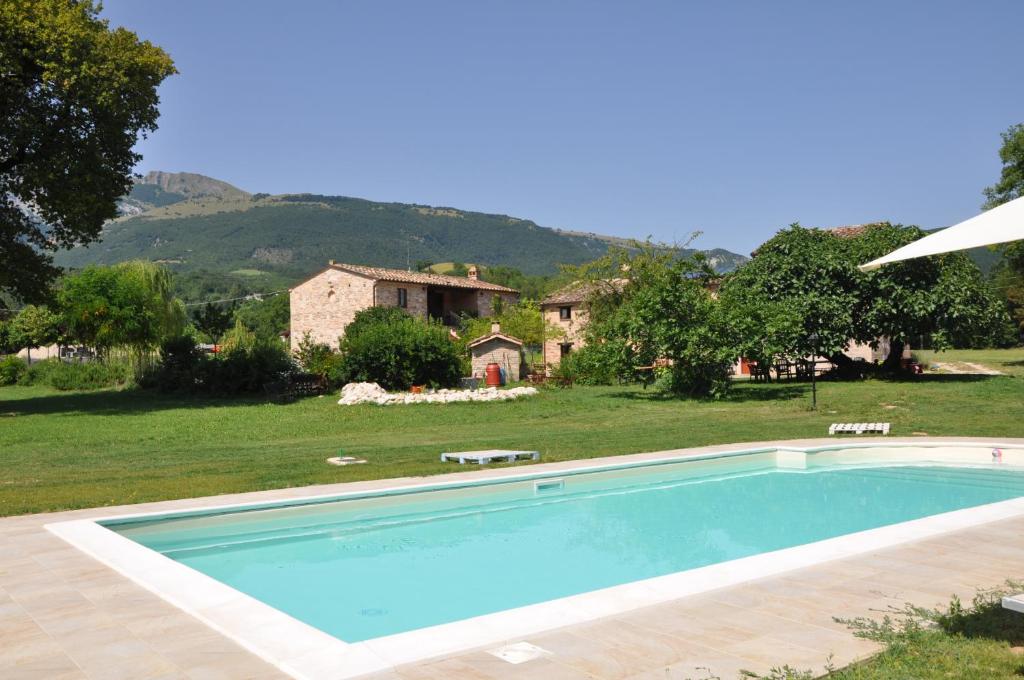 a swimming pool in front of a house at Antica Dimora in Sarnano