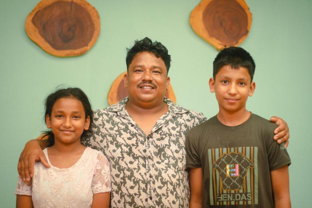 a man and two children posing for a picture at Odd Table Stay and Experiences in Mandrem