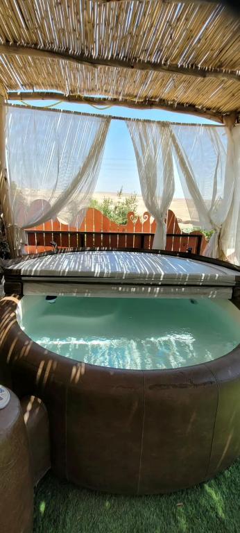 a pool with a hot tub in a backyard at רגע בזמן - Moment in time in Arad