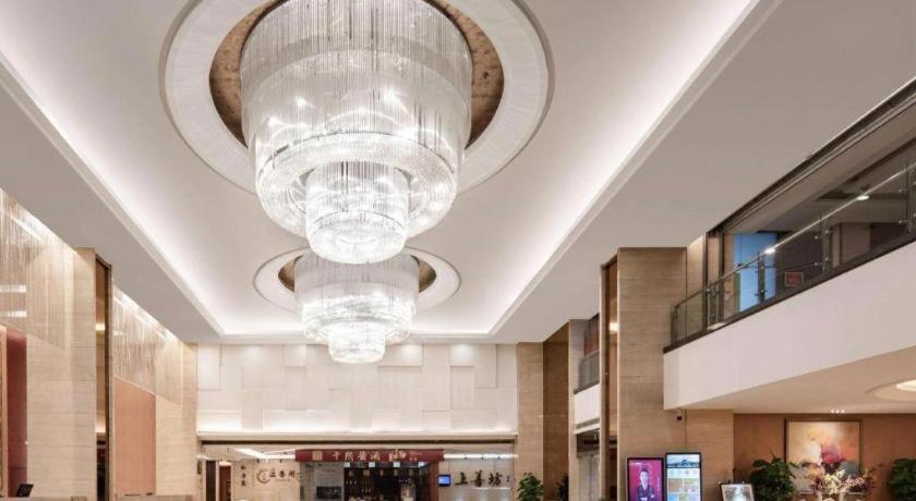 a large chandelier hanging from the ceiling of a building at Ramada by Wyndham Zibo in Zibo