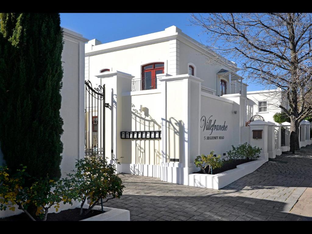 a white building with a sign on the side of it at 10 Villefranche in Franschhoek