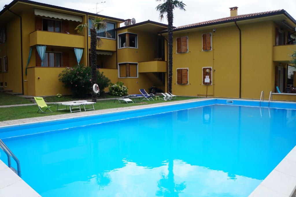 a swimming pool in front of a building at Atlantic in Bardolino