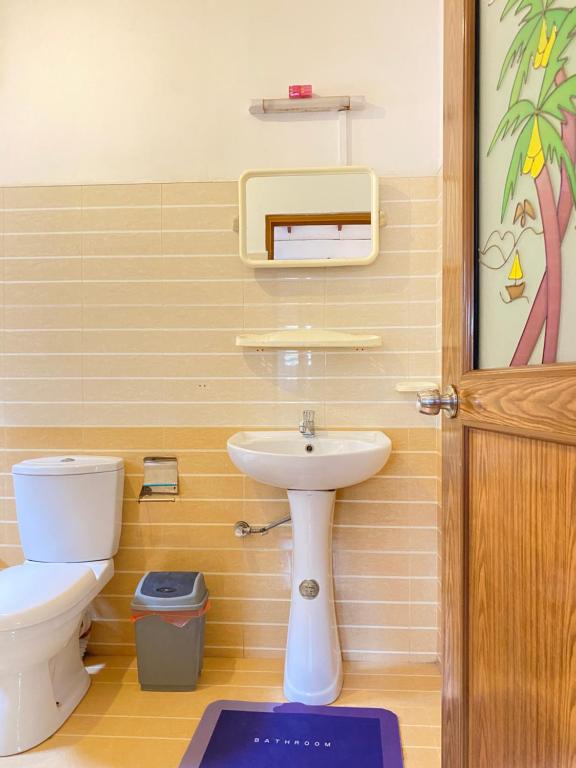 a bathroom with a toilet and a sink at Coco Bliss - Ahangama in Ahangama