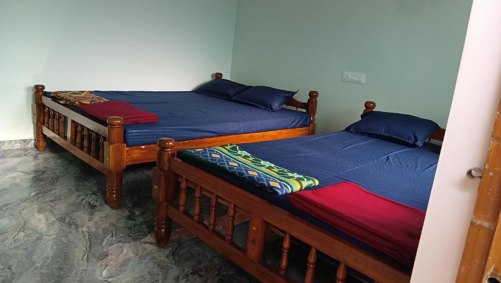two beds are in a room withthritisthritisthritisthritisthritisthritisthritisthritisthritis at Sateri Homestay Gokarna Beach in Gokarn