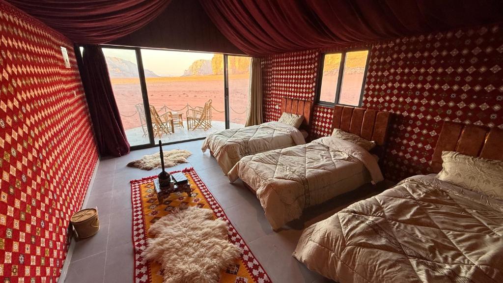 a bedroom with two beds and a room with a view at Bedouin Nature Camp in Wadi Rum