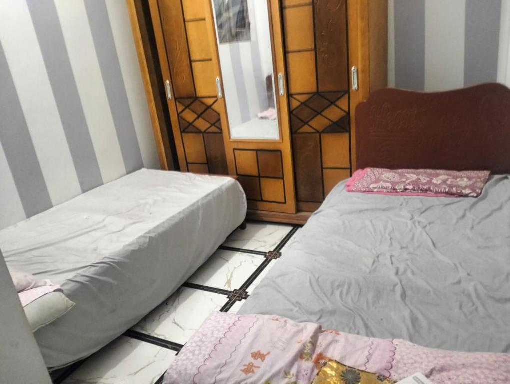 two beds sitting on the floor in a room at Safy Guest House in Jazīrat Aswān