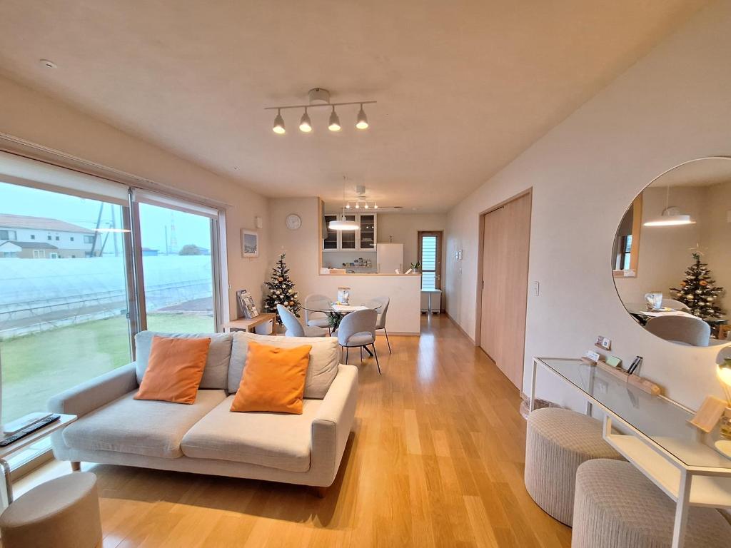 a living room with a couch and a table at Peaceful Garden Home in Ota, Entire 3BR Parking in Ota