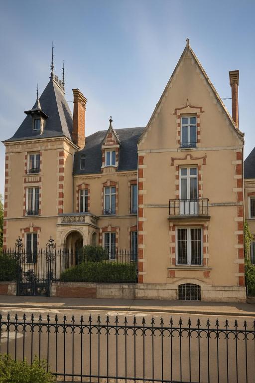a large house with a fence in front of it at Maunoury Citybreak in Chartres