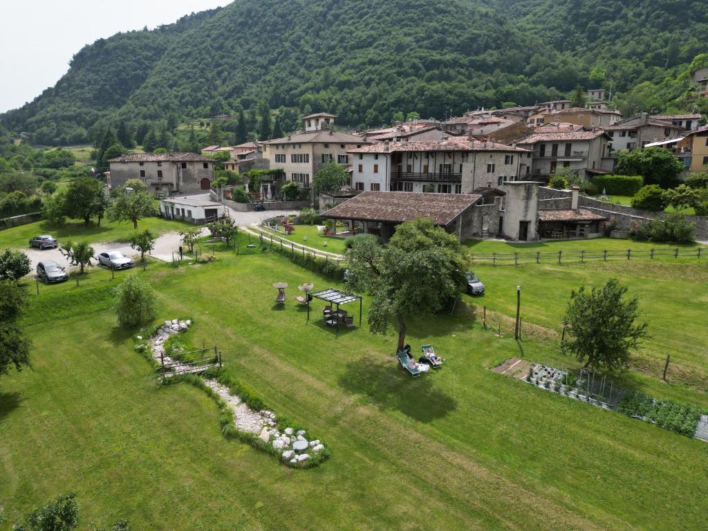 a small town with a green field and a mountain at Agriturismo Al Lambic in Tignale